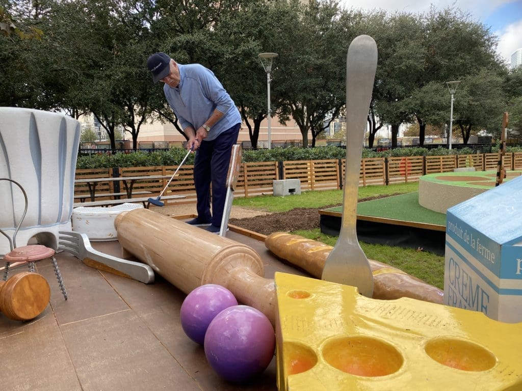 Architect and University of Houston professor and sometimes golfer Shafik Rifaat concentrates on his putt at Pixar Putt in Discovery Green.