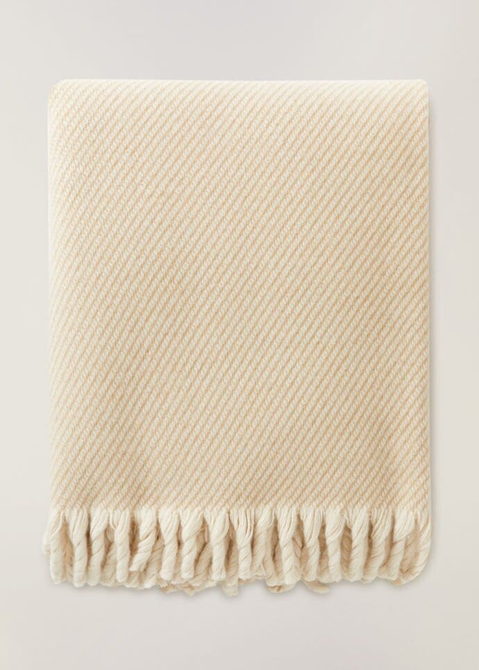 Nothing is cozier than snuggling up with this Loro Piana cream blanket this holiday.