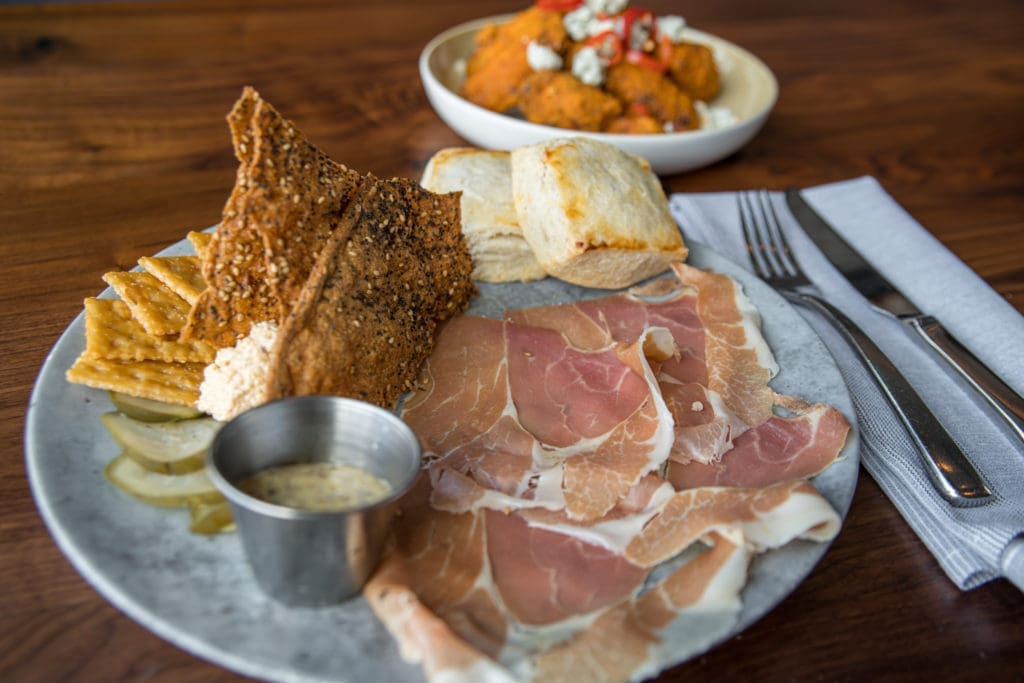 A signature dish: the ham and pimento cheese board served with beer mustard, pickles and warm biscuits. (Photo by Photos Care of Back Table Kitchen & Bar)
