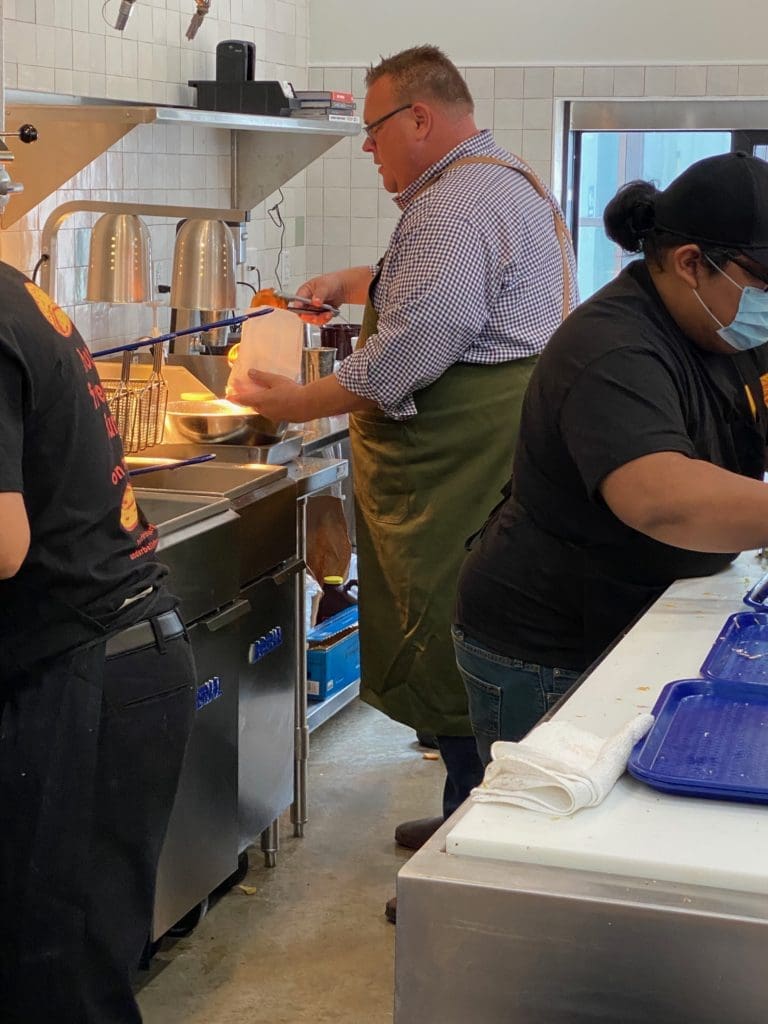 Underbelly Hospitality owner chef Chris Shepherd working the line at his spanking new Underbelly Burger in Houston Farmers Market. (Photo by Shelby Hodge)