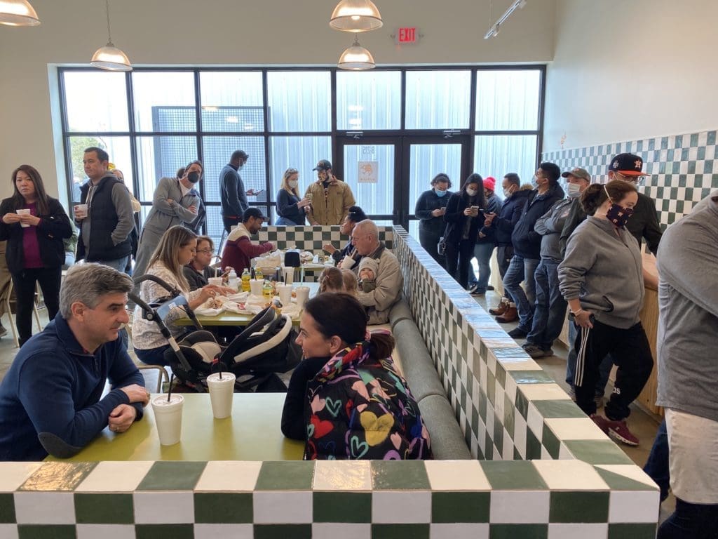 On day two of Underbelly Burger opening, young professionals were lining up for the delish burgers, chicken sandwiches and Chris Shepherd bacon sausage hot dogs. (Photo by Shelby Hodge)
