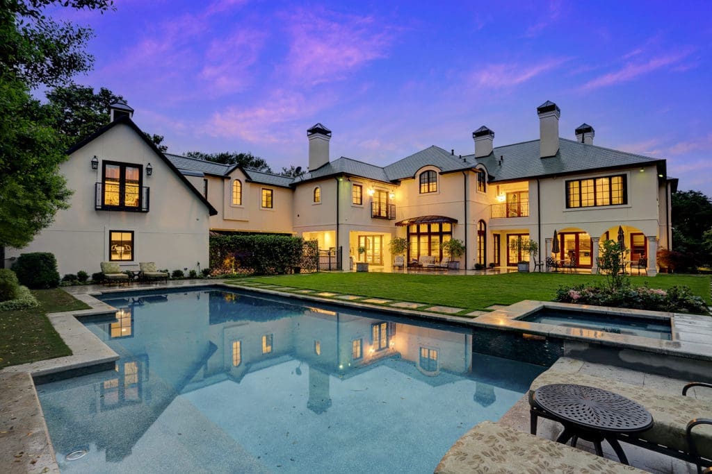 A view of this River Oaks estate at night. Resting on 25,000 square feet of manicured grounds, this property offers a private retreat.