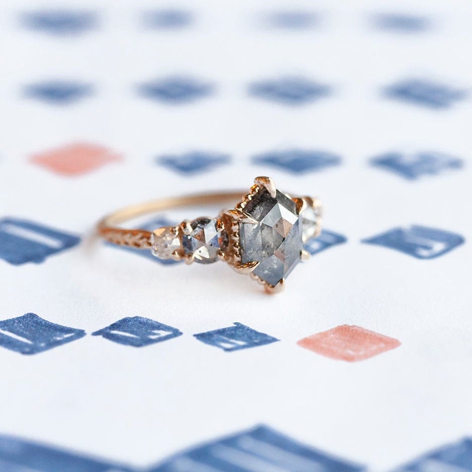Megan Thorne likes working in yellow gold. This is her Evergreen Five Stone setting with slick gray 1.49-carat rose cut hexagon center stone.