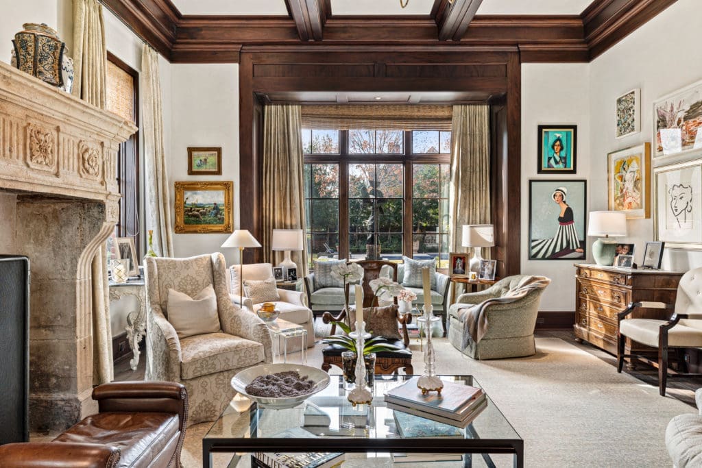 The living room in Frances and Tony Buzbee's home features one of the five wood-burning fire places in the River Oaks mansion. (Photo by Courtesy of Josh Gremillion for Douglas Elliman)