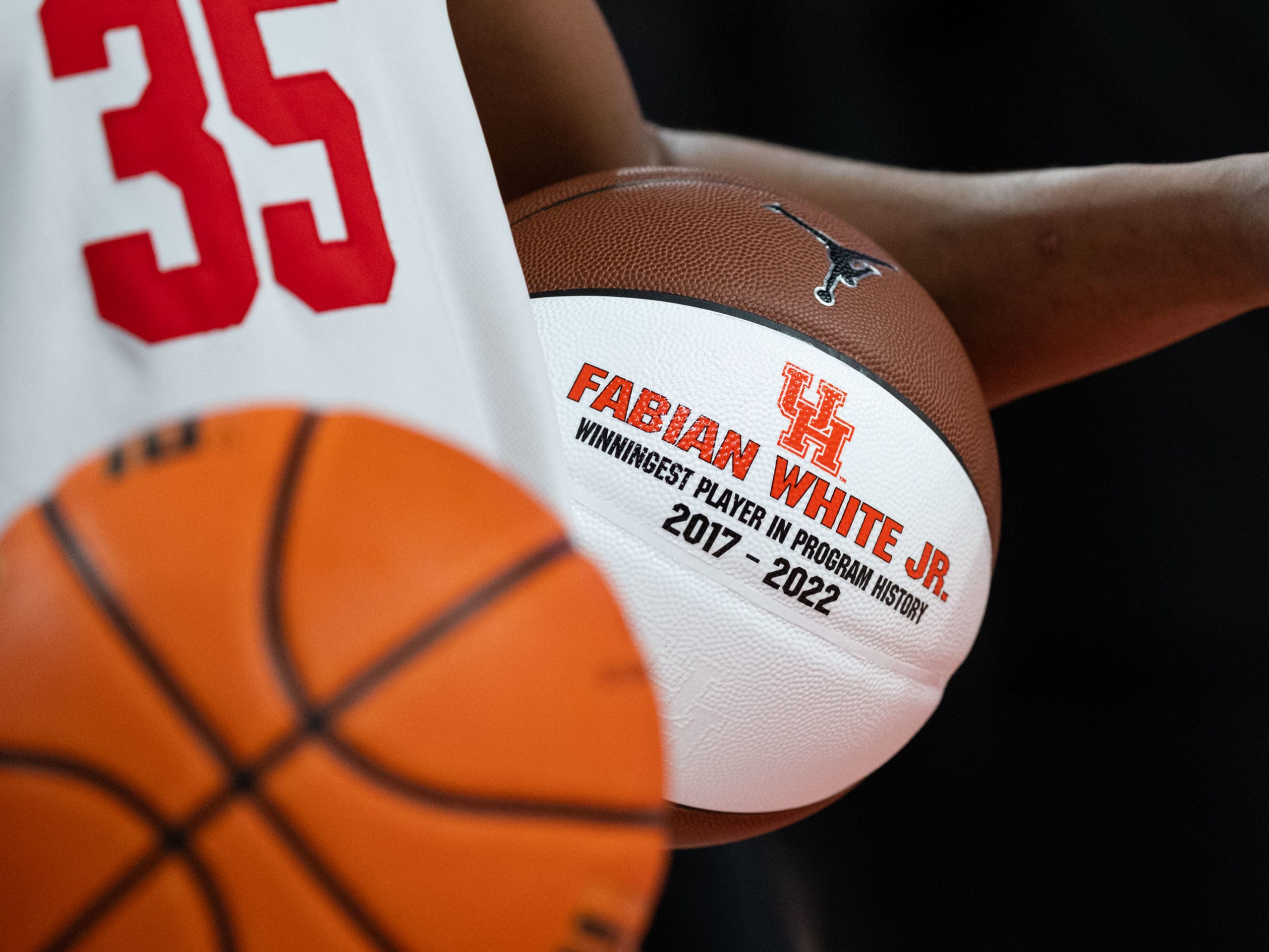 Fabian White Jr. cradled the basketball after winning his 110th game, more than any other player in the long, impressive history of the University of Houston basketball program. (Photo by F. Carter Smith)