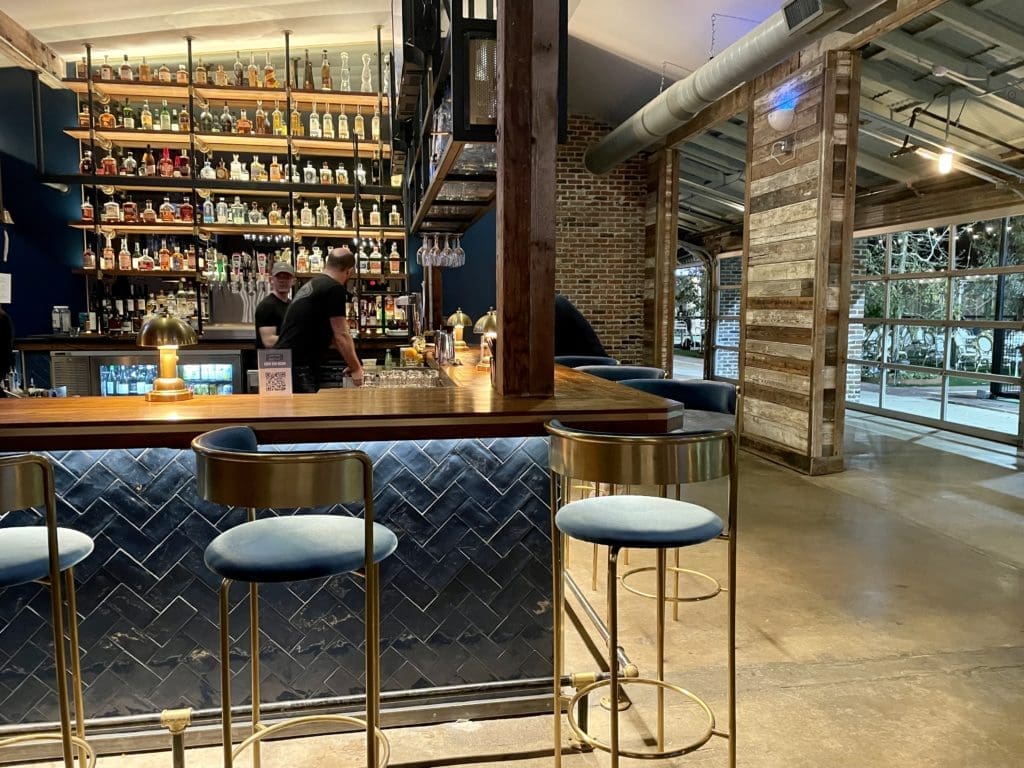 Courtside Kitchen's bar area opens onto lush patio and pickleball courts. (Photo by Courtney Dabney)