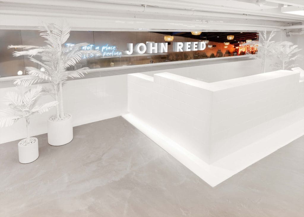 A slick, stark space helps cleanse your visual palate before entering John Reed's color-drenched gym.  (Photo by JOHN REED Fitness)