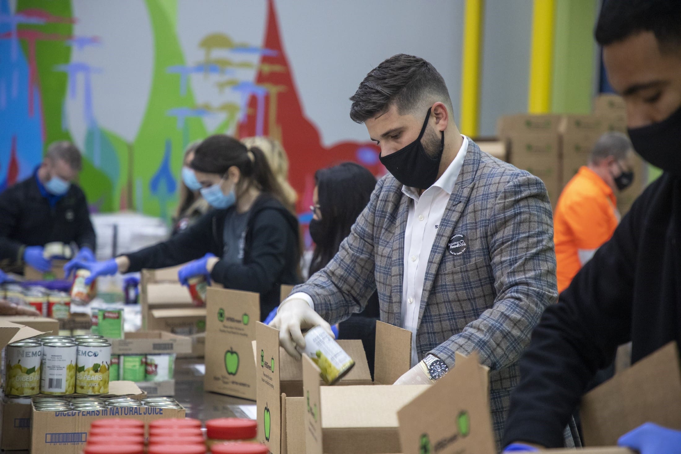 volunteers packing boxes at the Houston Food Bank (Photo by Photos The Houston Food Bank)