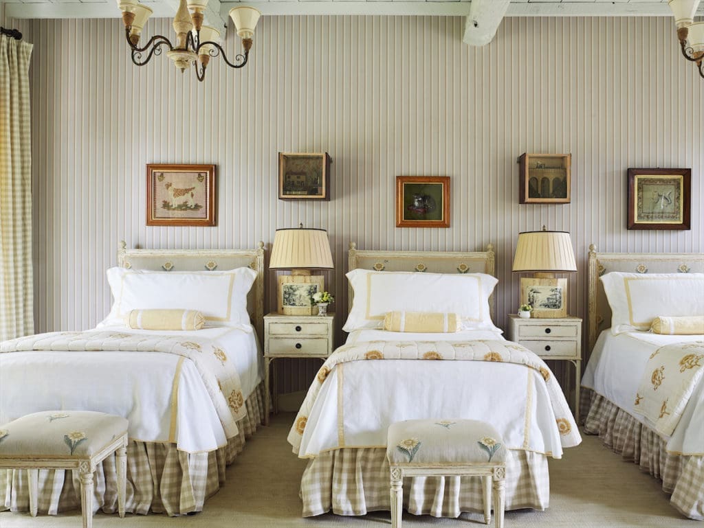 Chelsea Textiles headboards upholstered in sunflower embroidered fabric. Les Indiennes quilts are also printed with sunflowers. (Photo by Tria Giovan)