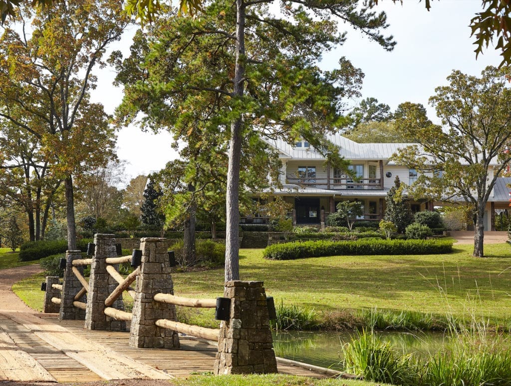 The main house is surrounded by 10 acres of natural landscaping, winding roads, and bridges. (Photo by Tria Giovan)