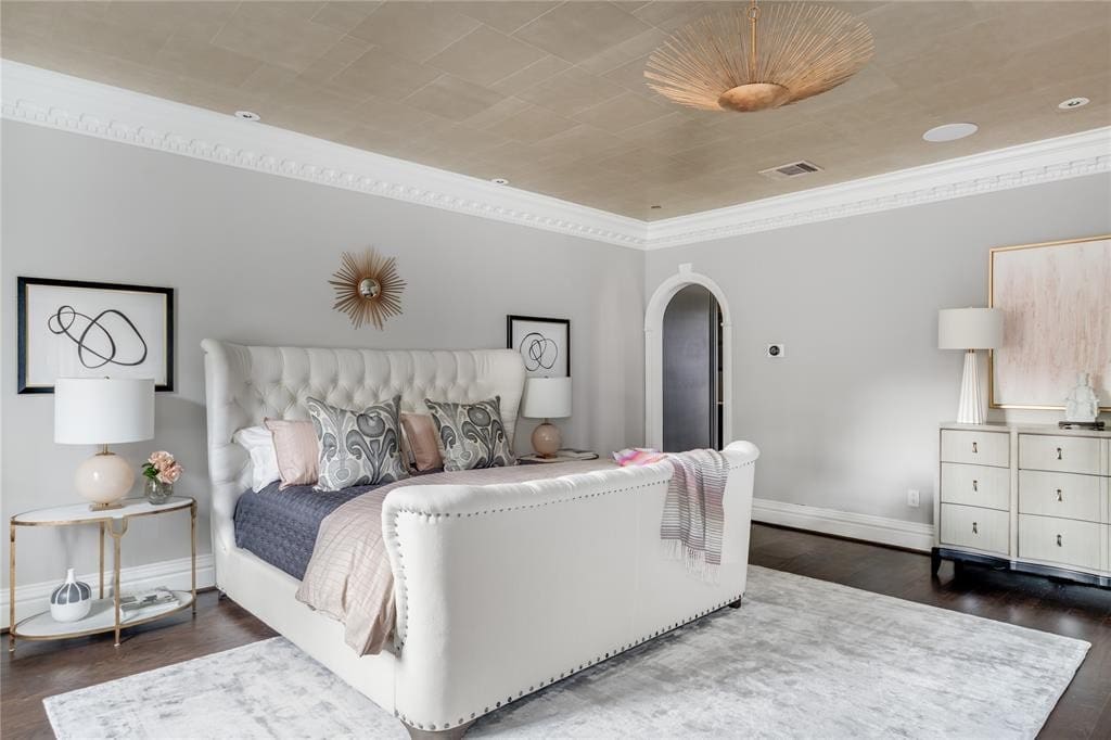 Alexa Hampton's deep rouge walls have been painted a more soothing hue, but a gorgeous brass chandelier and crisp plaster moldings still ground the master bedroom. (Photo by Costa Christ Media)