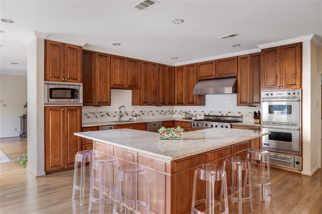 The kitchen features updated stainless steel appliances. 