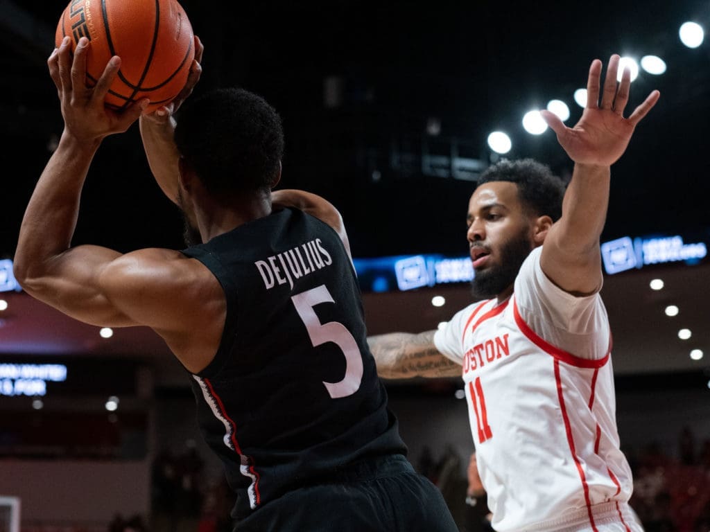 Kyler Edwards often guards the opposing team's best player. Here, he makes talented Cincinnati guard David DeJulius' life miserable. (Photo by F. Carter Smith)
