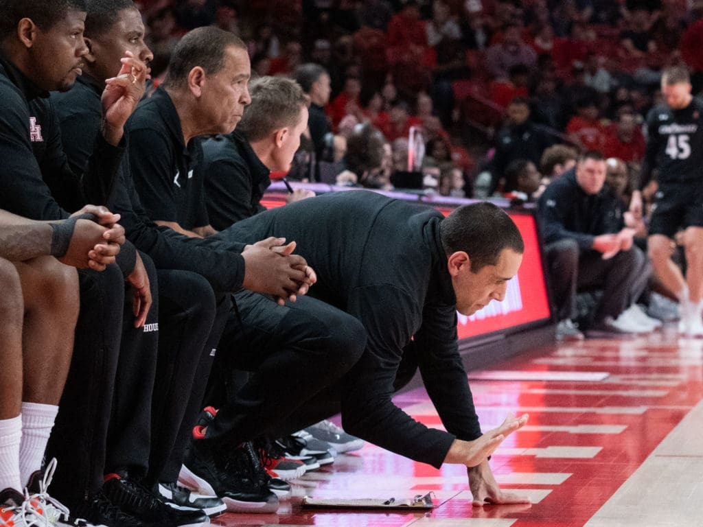 University of Houston assistant coach Kellen Sampson pounds the floor to pick up the intensity. (Photo by F. Carter Smith)