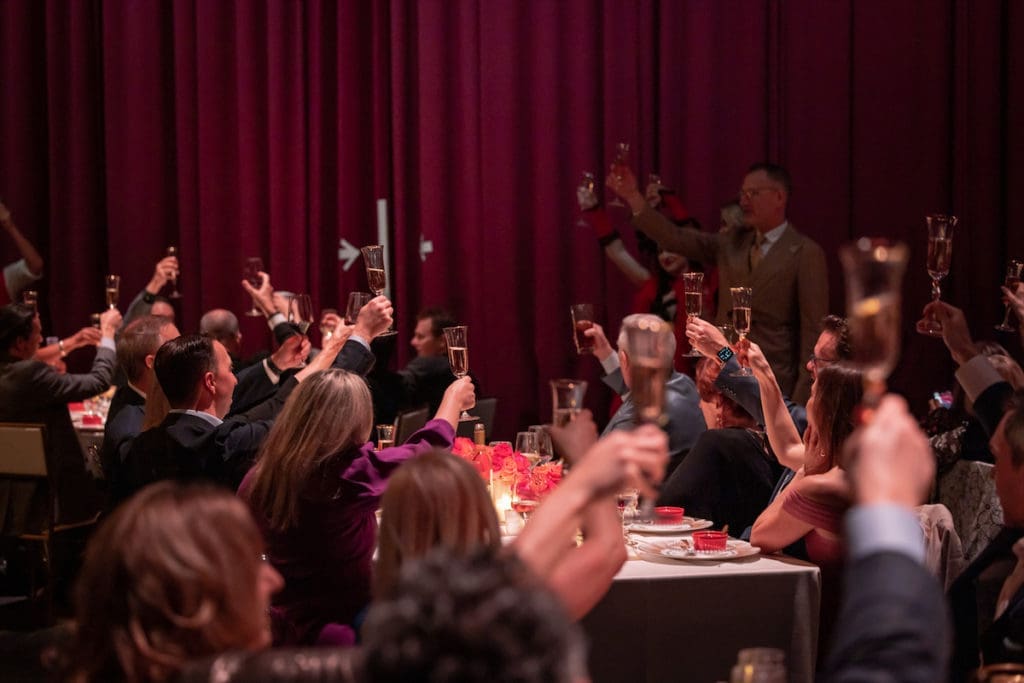 Dinner on Stage attendees toast the evening. (Photo by Thomas Garza Photography)