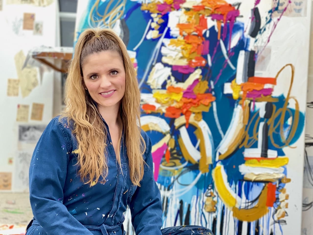 Ash Almante poses in front of one of her works.