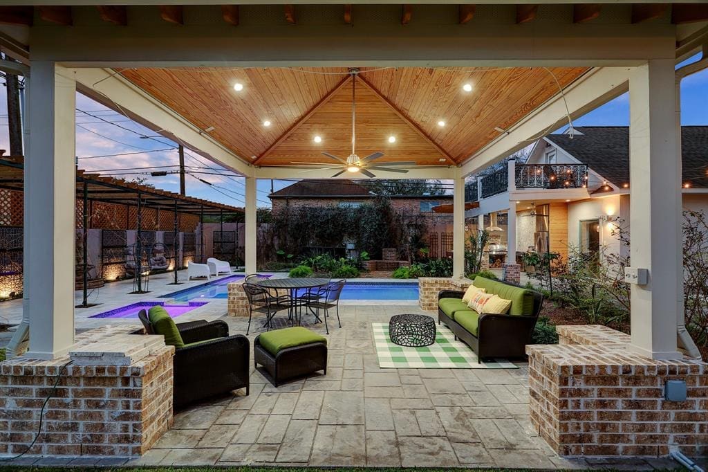 Multiple entertaining spaces surround the pool at 607 Harvard Street in The Heights. (Photo by TK Images)