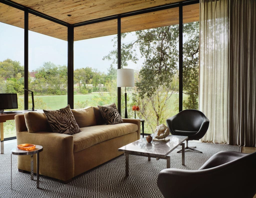 Weldon Turner designed the homeowner's office as a treehouse-like retreat overlooking the land. The cedar ceiling is extended past the windows to the outside. Furnishings are from the homeowner's previous house. (Photo by Lisa Petrole)