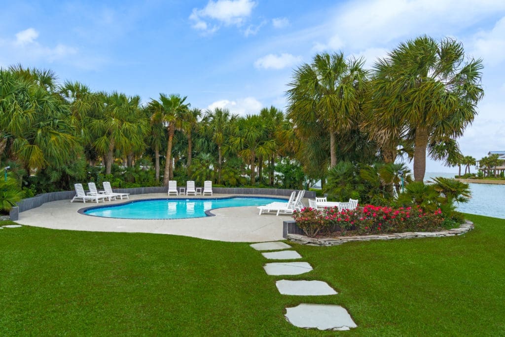 Mature landscaping adds an ambience of resort living to the property at 16502 Bayfront Drive in Jamaica Beach  (Photo by Sonya Bertolino for Douglas Elliman Realty)
