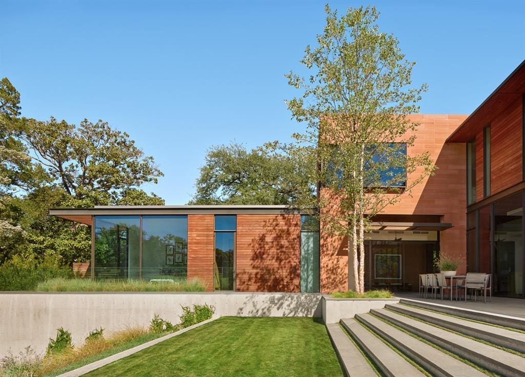 The lawn is meticulously kept and manicured to compliment surrounding  nature. 