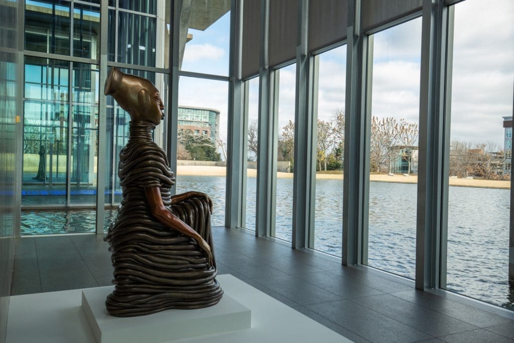 Modern Art Museum - Wangechi Mutu's "The Seated III," 2019, with its view of the reflecting pool. 