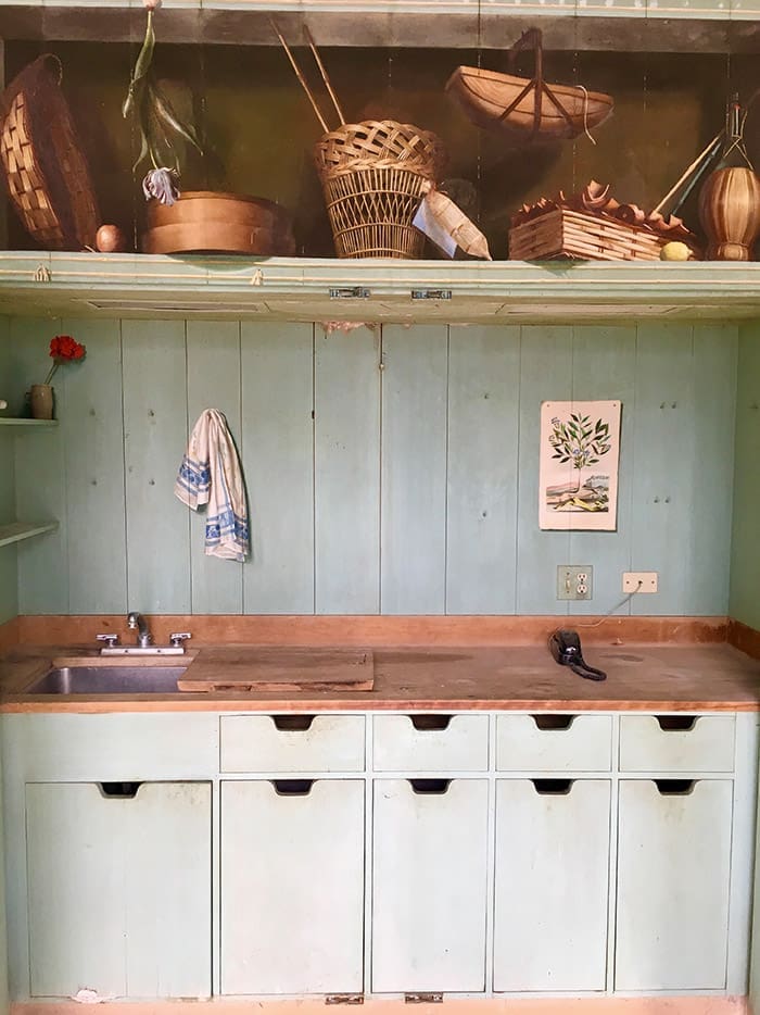 Trompe l'oeil cabinets in the greenhouse that open to reveal a bar sink.