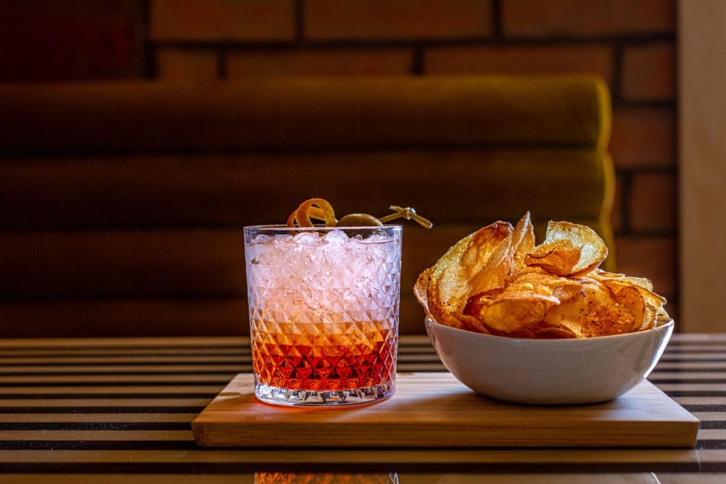 Come in at happy hour for a cocktail or glass of wine and an array of salty snacks at Lees Den in Rice Village. (Photo by Jenn Duncan)