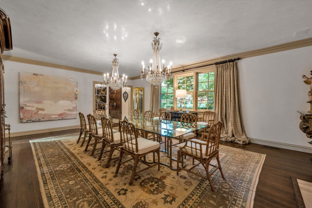 Chandeliers glow in the Venetian plastered ceiling of the formal dining room.