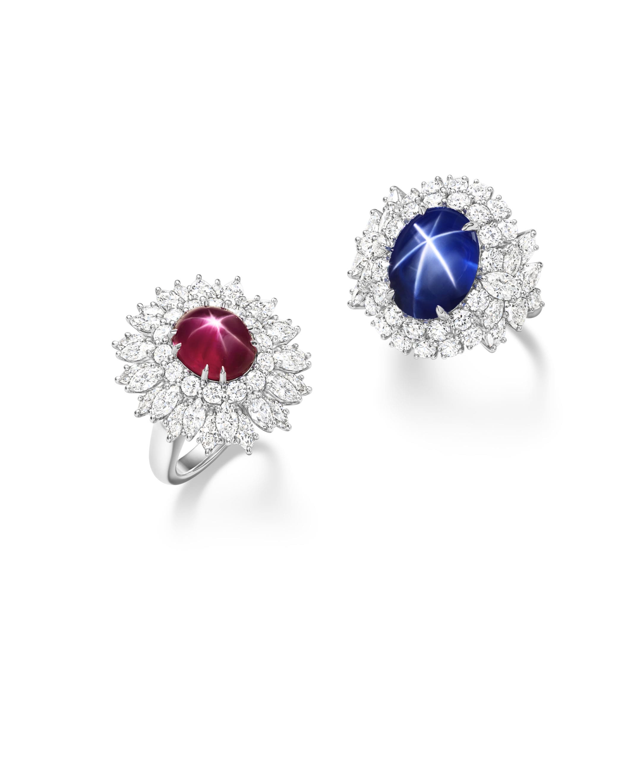 From left: Harry Winston Star Ruby ring from the Marvelous Creations Collection with 4.91-carat star ruby and round brilliant and marquise-shaped diamonds, set in platinum. Harry Winston Star Sapphire ring from the Marvelous Creations Collection with 6.82-carat oval cabochon star sapphire center stone and marquise and round brilliant diamonds, set in platinum.