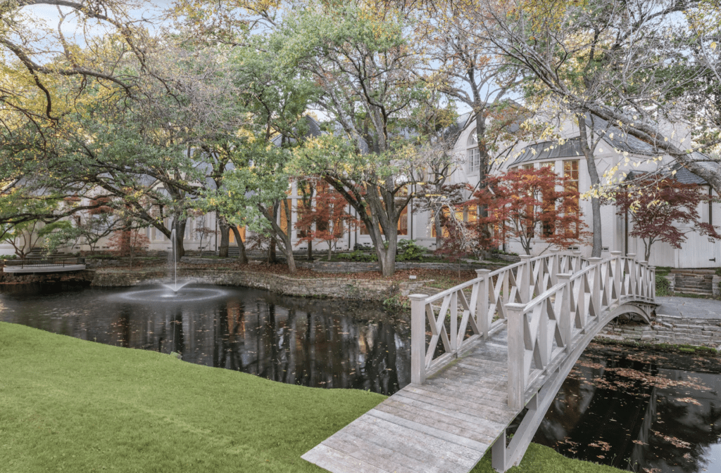 Located at 9250 Meadowbrook Drive, the home is situated on a 2.3-acre corner lot backed by a creek that’s visible from multiple rooms