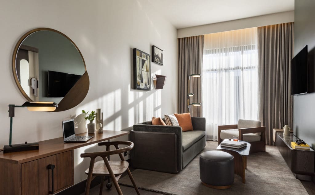 The Mile High Suite at Thompson Denver includes a lounge area and desk. (Photo by Julie Soefer)