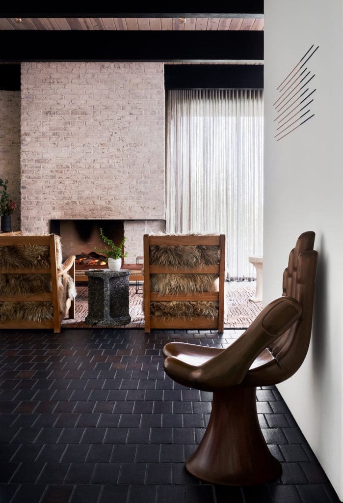 In the living area, a rare 1960s renovated Pedro Friedeberg. Above, Catherine MacMahon's "Align a Line" installation from Erin Cluley Gallery. The floors are manganese ironspot brick, and the brick walls were given a German smear treatment. (Photo by Stephen Karlisch and Robert Tsai)