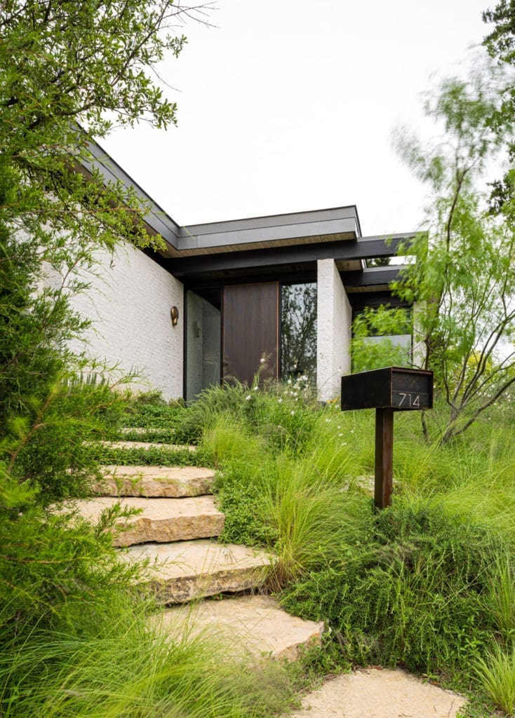 The bronze front door was made by Forms+Surfaces. Cast-bronze sconce by Studio Henry Wilson, Australia. (Photo by Stephen Karlisch and Robert Tsai)