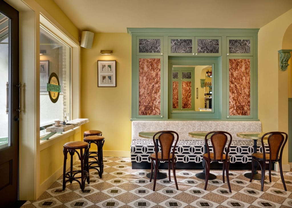 Café Duro is inspired by the work of Italian architect Renzo Mongiardino; faux-marbre wallpapers are custom and fabrics are Timothy Corrigan for Perennials and Pierre Frey. (Photo by Stephen Karlisch)