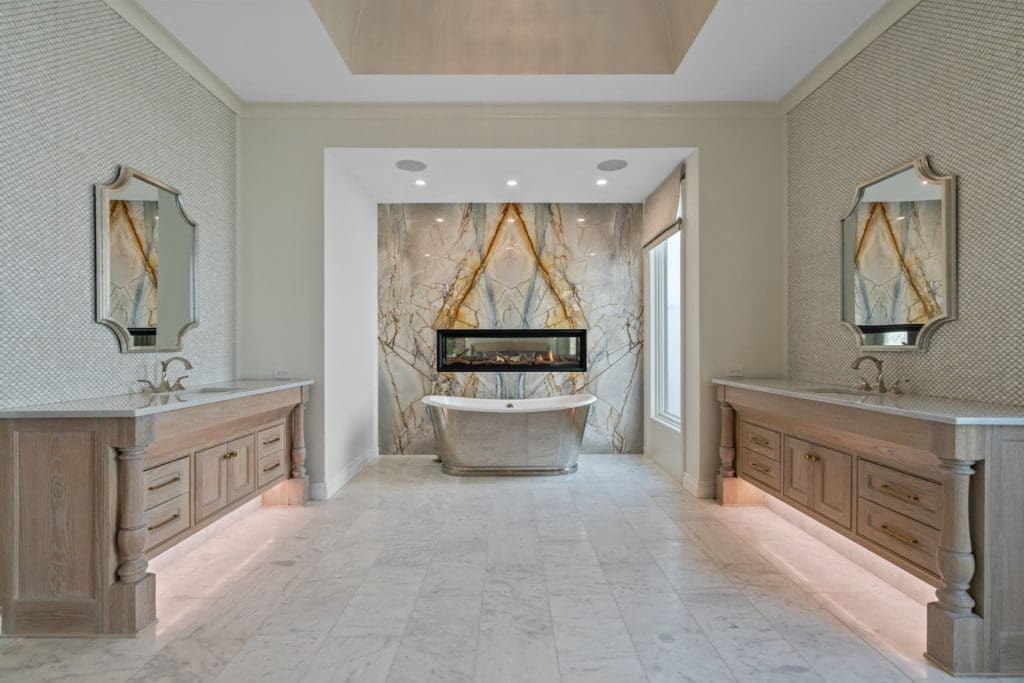 The dual sided primary bath with its inspiring see-through fireplace and soaking tub backed by stunning granite.