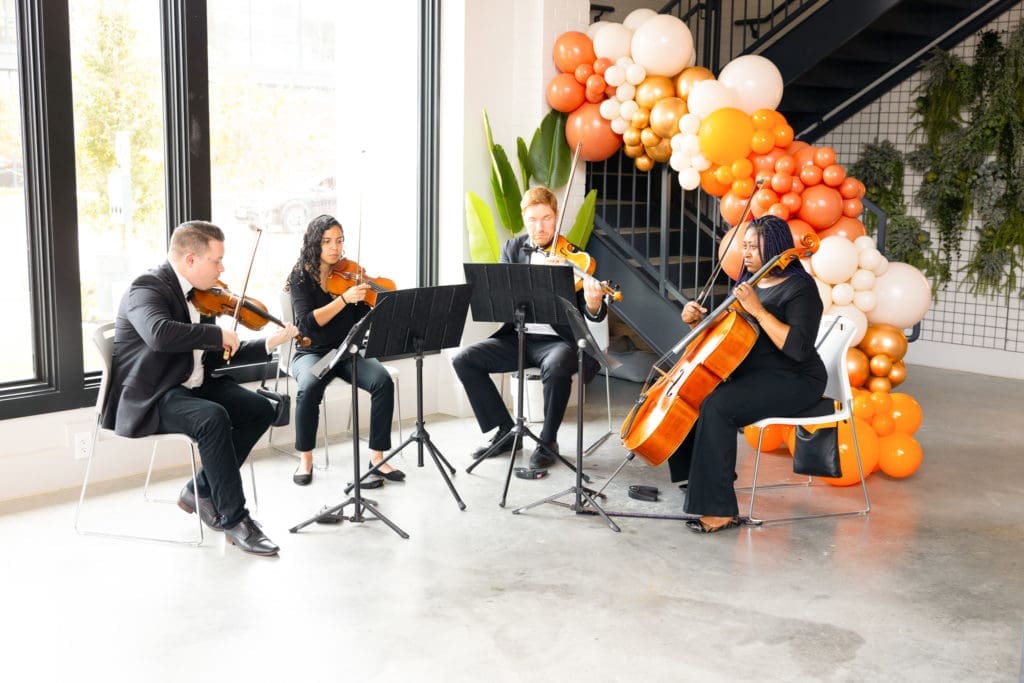 Divi Strings performs at Nancy Almodovar's birthday brunch at Nan & Company Properties flagship office (Photo by Nan Studios)