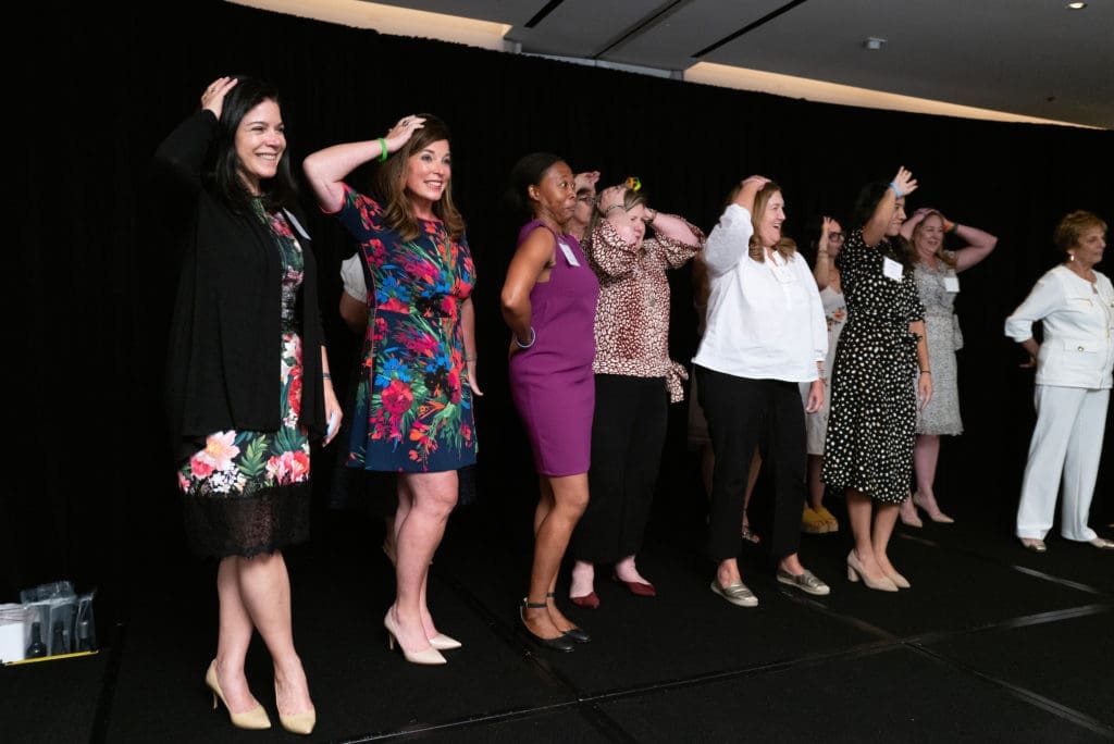 Dress for Success supporters getting into the Heads or Tails game at the DFS Houston fundraiser at the Four Seasons Hotel. (Photo by Daniel Ortiz)