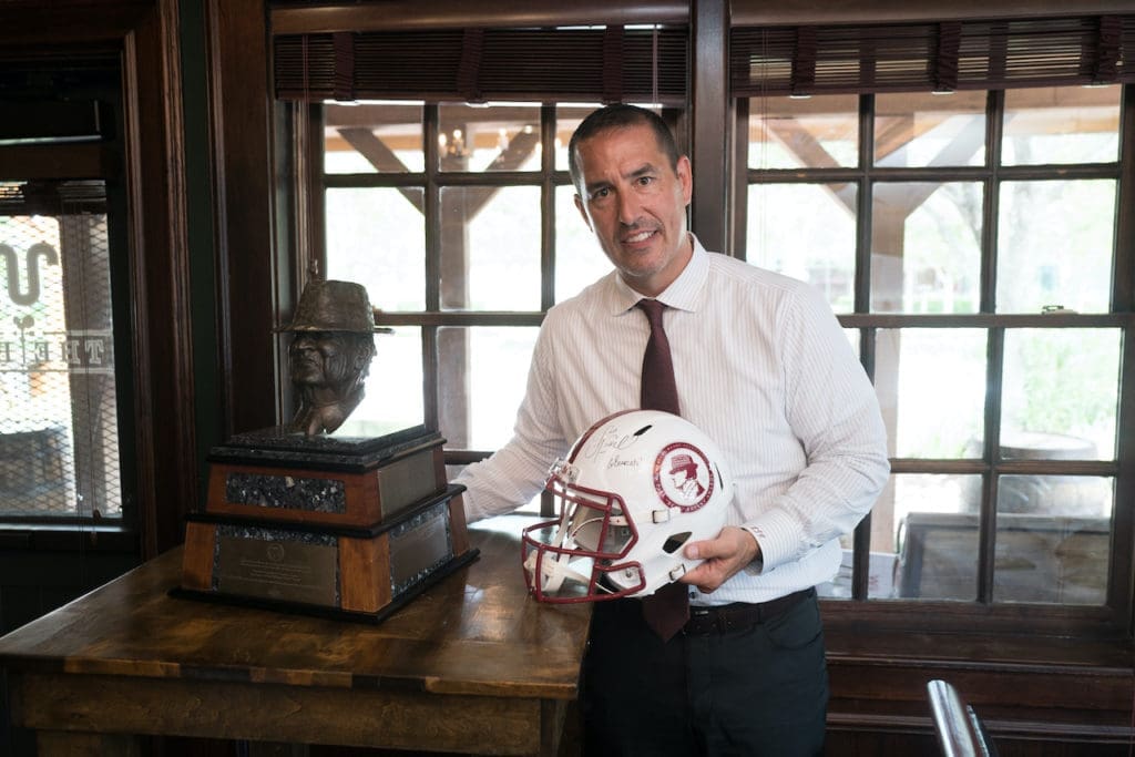 2021 Paul 'Bear' Bryant Coach of the Year honoree Luke Fickell displays his trophy and helmet at the American Heart Association luncheon (Photo by Daniel Ortiz)