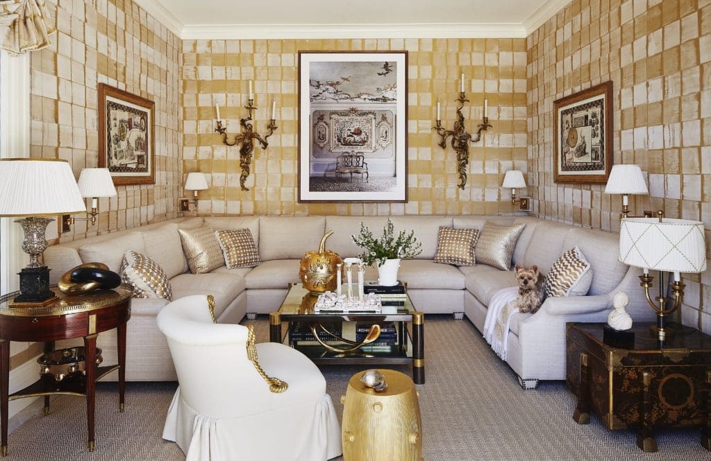 In a Bridgehampton beachside home, an Anya Larkin hammered silk sheathes the sitting room, which features a photograph by Jean François Jaussaud. The Beauvais carpet is made of woven metallic leather. (Photo by William Abramowicz)