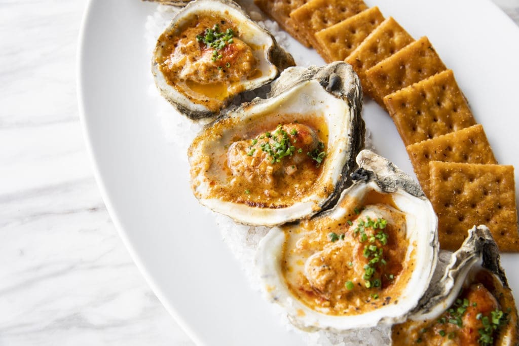 One of their former signature appetizers, Viet-Cajun roasted oysters made the move to the new Georgia James menu. Photo by Julie Soefer.