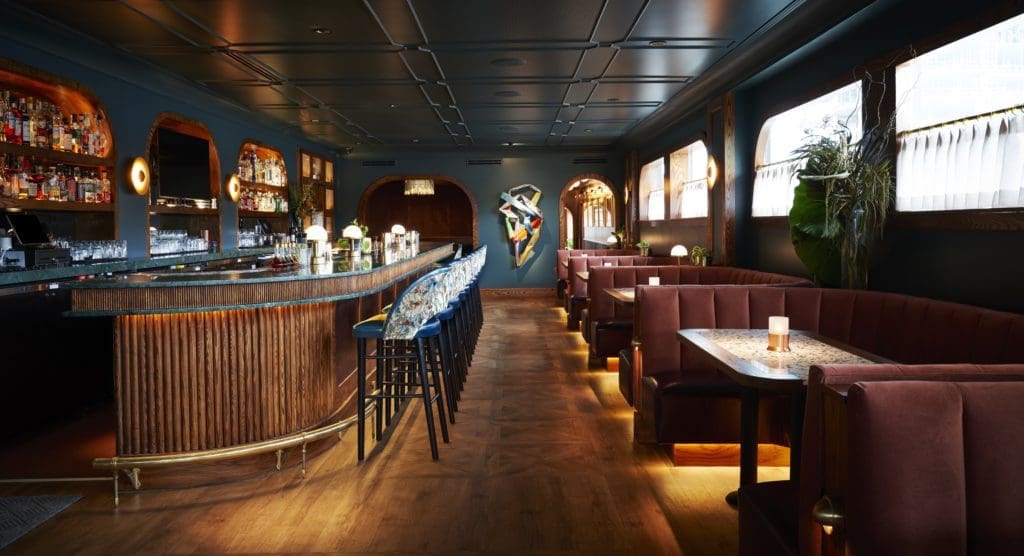 Step through the velvet drapes of the Clifton Club and enter the shotgun-style bar, which feels like a dining train car built during the golden age of travel. (Photo by Jonathan Zizzo)