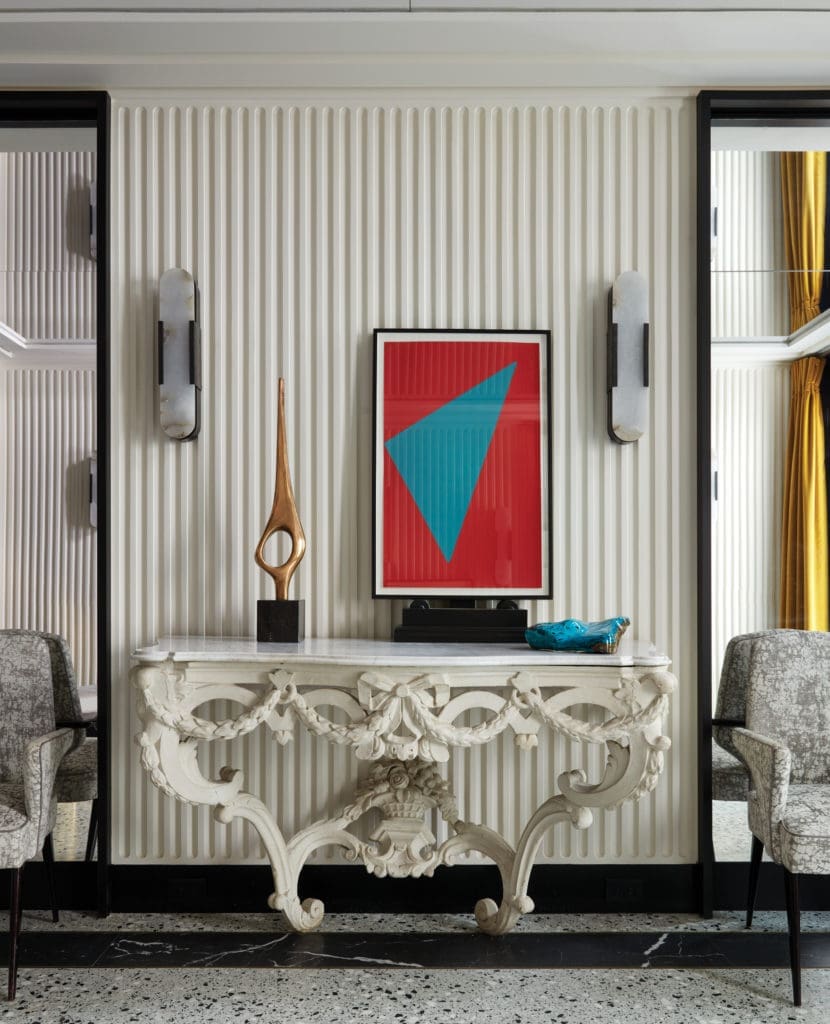 Antique Louis XV console table. Pair of 1950s Italian armchairs, Kelly
Wearstler sconces