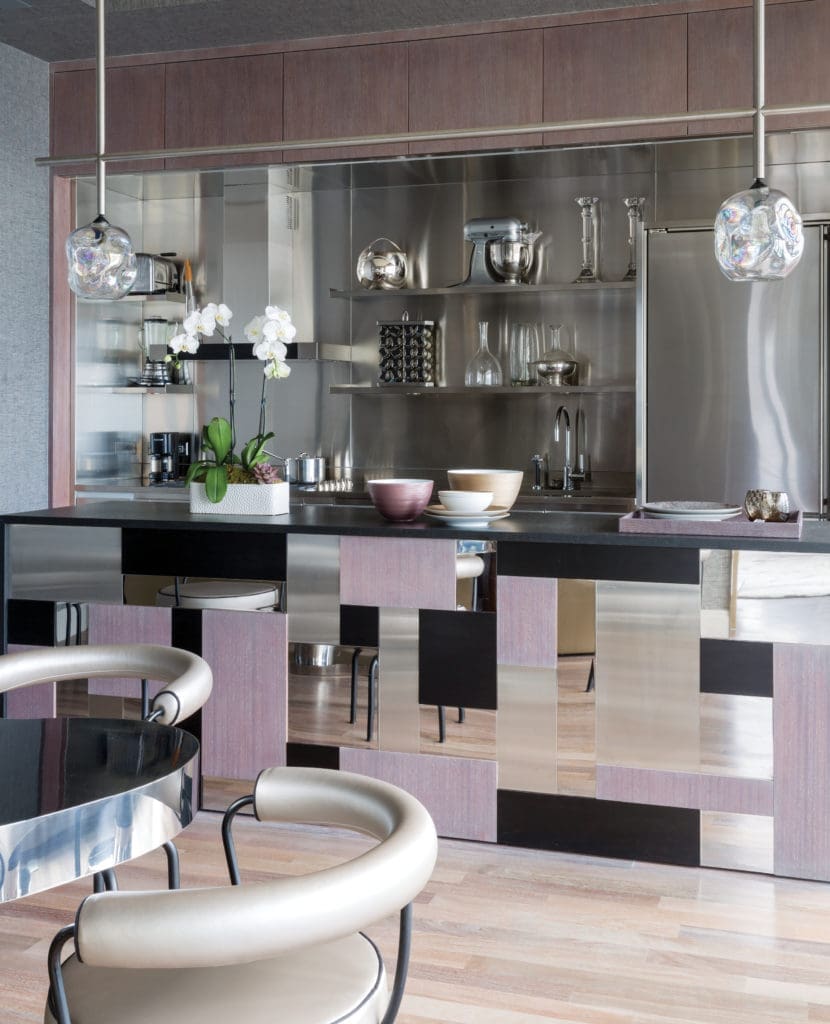 In the New York City Annabelle Selldorf-designed building, a bar is custom-designed by Jean-Louis Deniot in marquetry of polished stainless steel, brushed stainless steel, ash-stained teak and ebony-stained teak, top and sides in brushed black granite. Custom-designed JLD pendant lights with glass globes by John Pomp