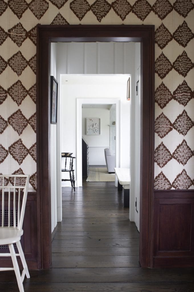 A light, minimal entry hall provides breathing space between the living room and dining room of this New England farmhouse. (Photo by William Waldron)