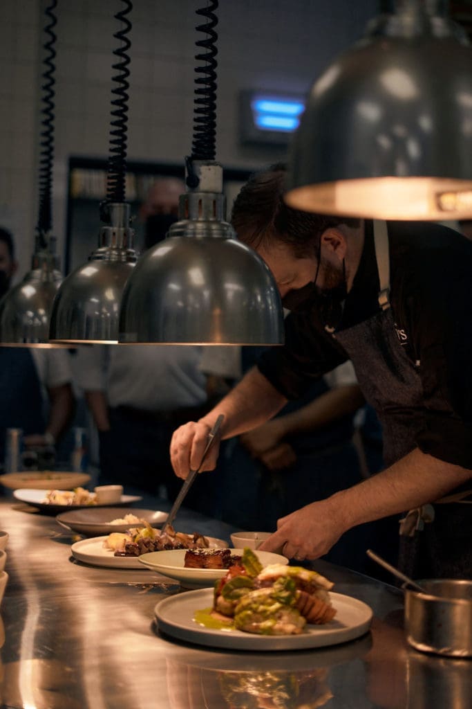 The Killen's team preparing lobster tail with chorizo and white bean papusas and picked red cabbage as part of the Don Manuels Takeover. (Photo by Studio Caribe)
