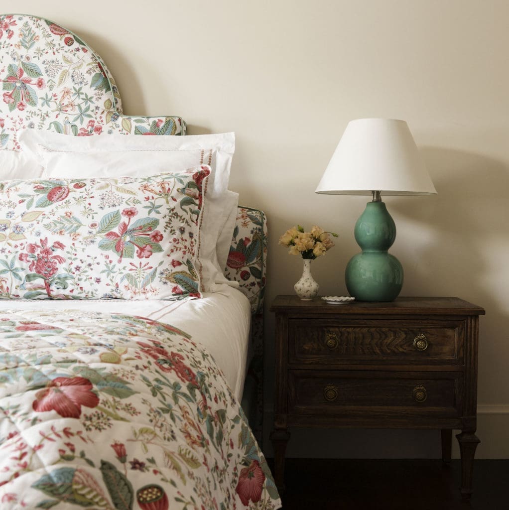 In the guest bedroom Schumacher, Pomegranate Botanical in Document is employed in the headboard and linens. (Photo by Jack Thompson)