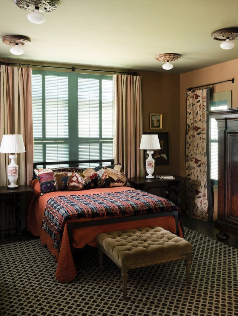 Jill Brown’s bedroom, with draperies made from antique embroidered fabric, and a quilt inherited from family. (Photo by Jack Thompson)