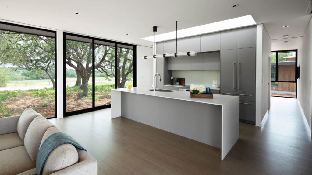 Driftwood Villas modern kitchen design with skylights and waterfall countertops.