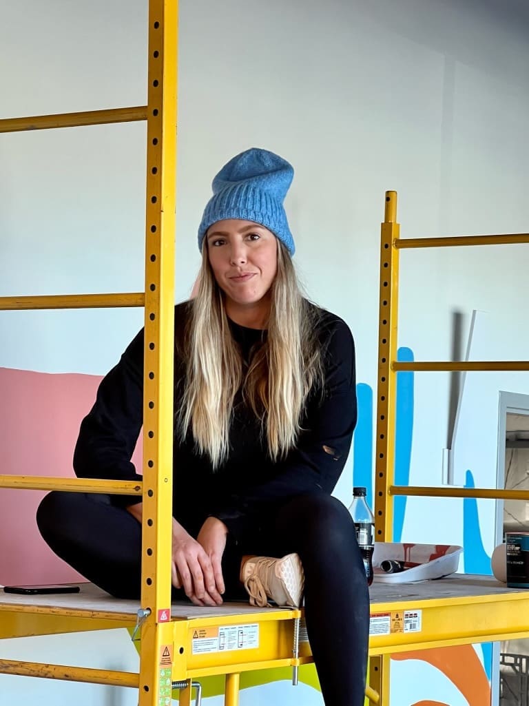 Nicole working on the Good Earth mural. (Photo courtesy the artist.)