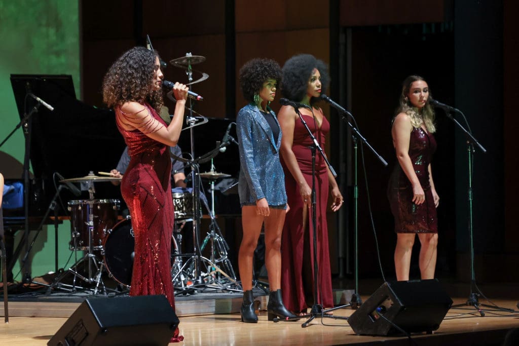 Khaili Sam-Sin, also known as SAM/SIN, sings with Triniti Hymes-Richardson, Krystal Hardwick, and Molly Shanahan. (Photo by Johnny Than)